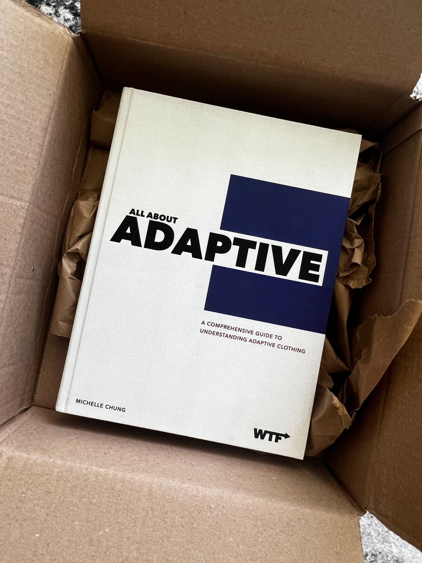 All About Adaptive inside a cardboard box