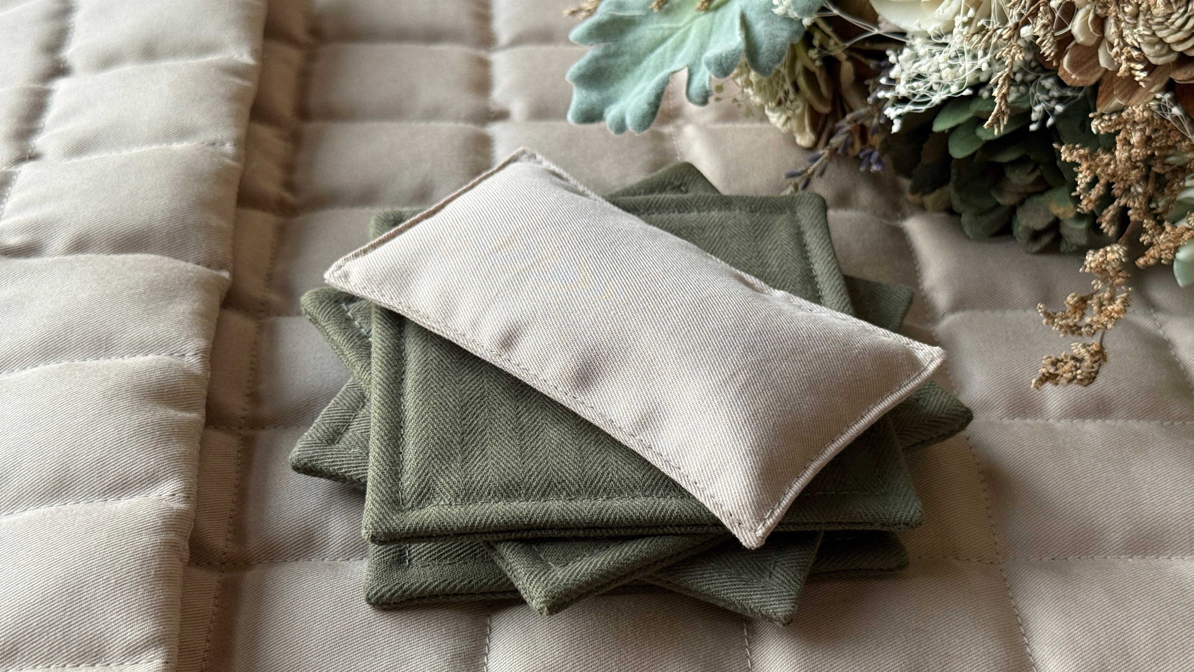 Cover photo of Not What It Seams: Ground Zero (Unit 1) showcasing the finished projects from the course: fabric coaster, hand warmer, and heating pad